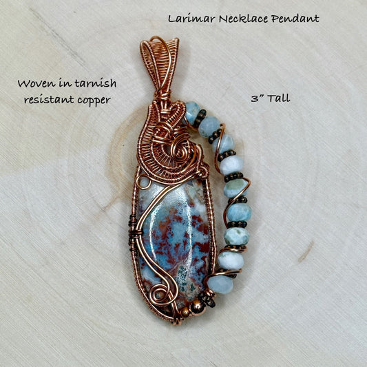Larimar necklace pendant with copper wire wrapping on a textured white background