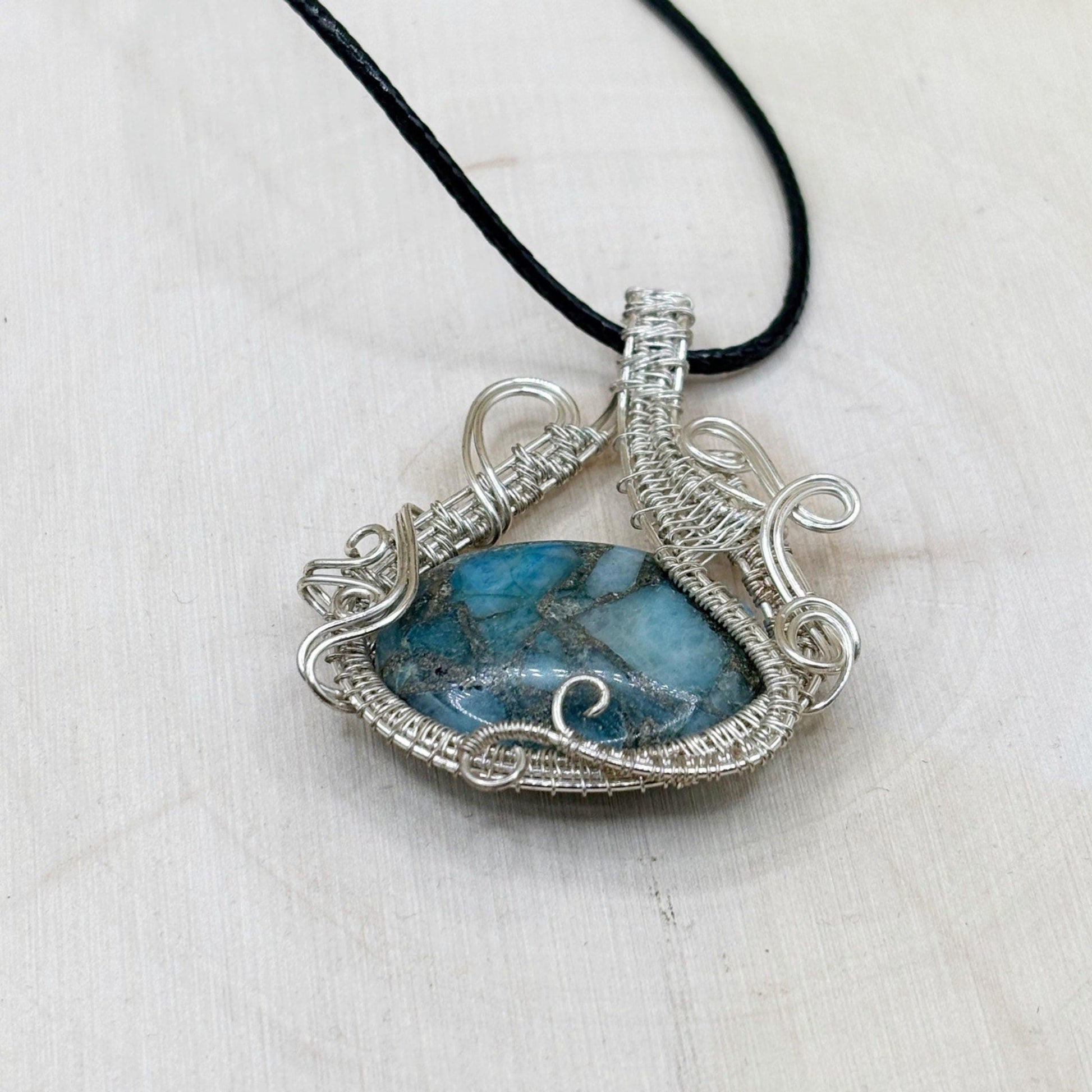 Necklace with a blue stone pendant on a white background