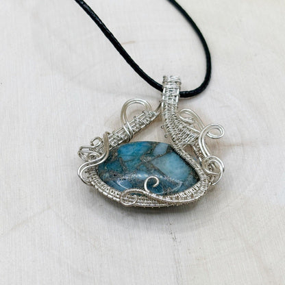 Necklace with a blue stone pendant on a white background