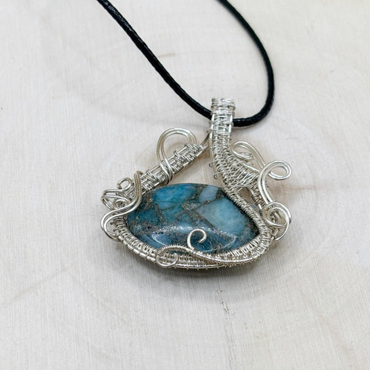 Necklace with a blue stone pendant on a white background-p