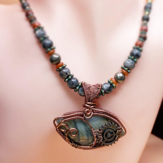 Beaded necklace with intricate copper wire wrap pendant as the focal