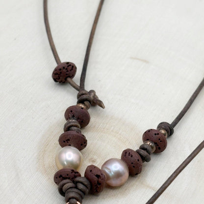 Necklace with brown beads and pearls on a light background