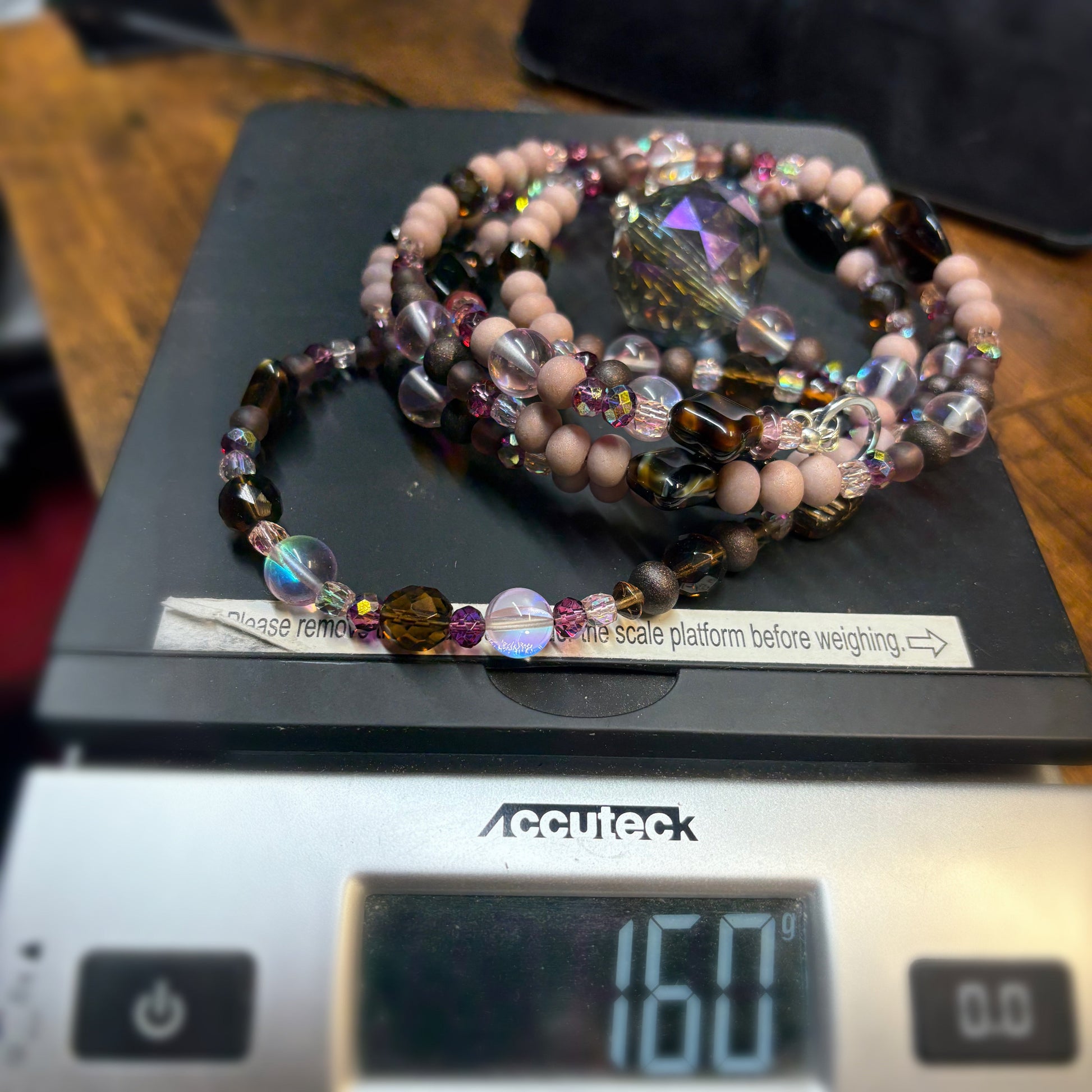 Beaded suncatcher on a digital scale with a visible weight reading.