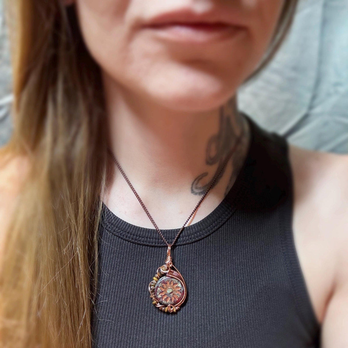 Model wearing a necklace showing handmade wire wrapping