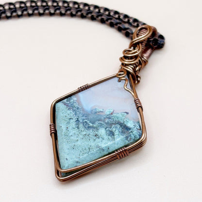 Necklace with a Moss Agate stone pendant on a white background