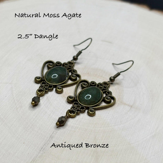 Antiqued bronze dangle earrings with natural moss agate stones on a light background-p