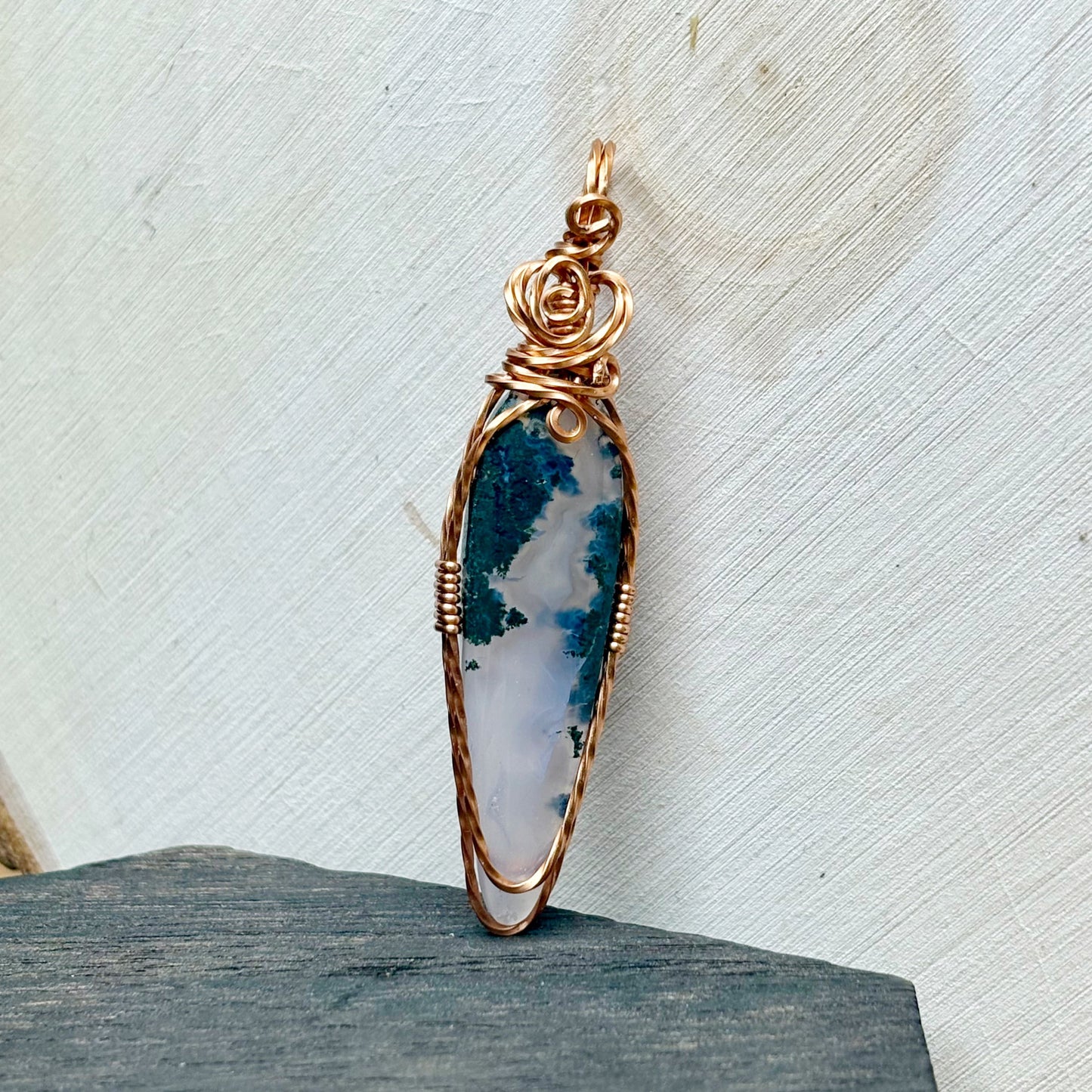 Jewelry pendant with a natural stone design on a textured surface