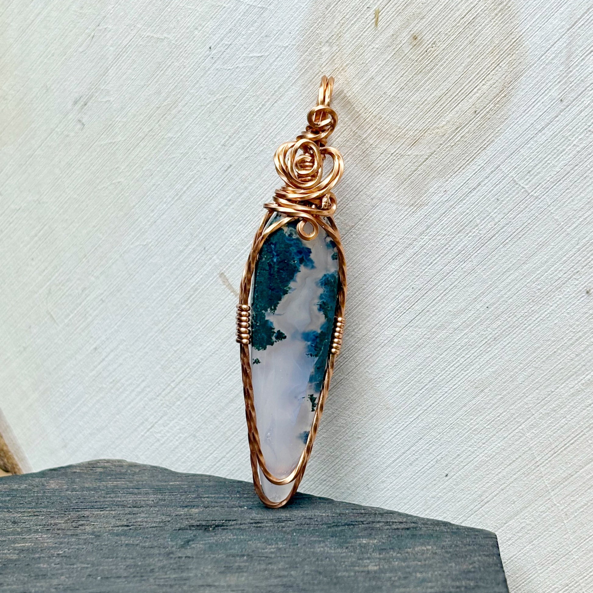 Jewelry pendant with a natural stone design on a textured surface