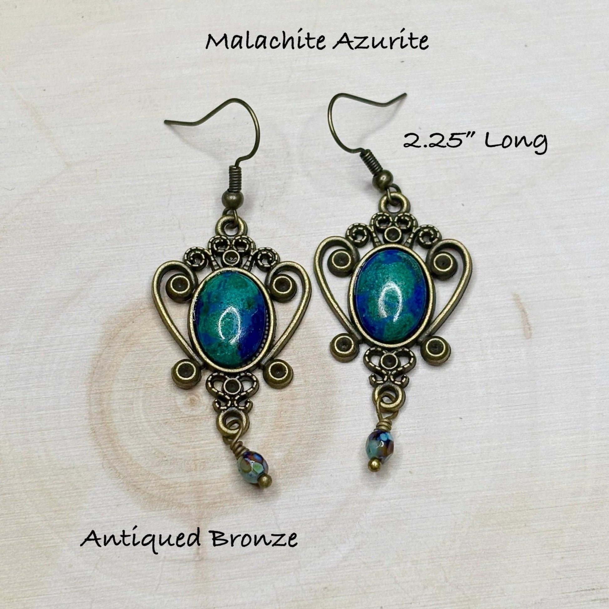 Pair of Malachite Azurite earrings with anted bronze finish on a light background