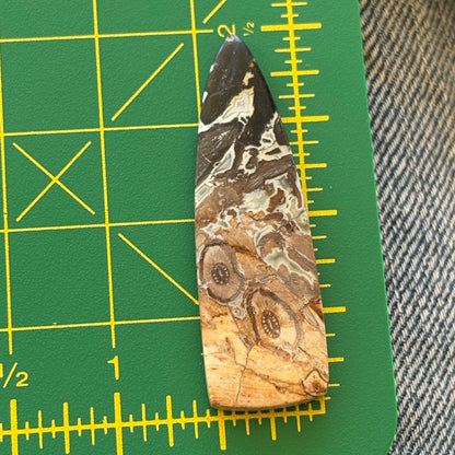 Marbled stone on a green cutting mat with yellow grid lines