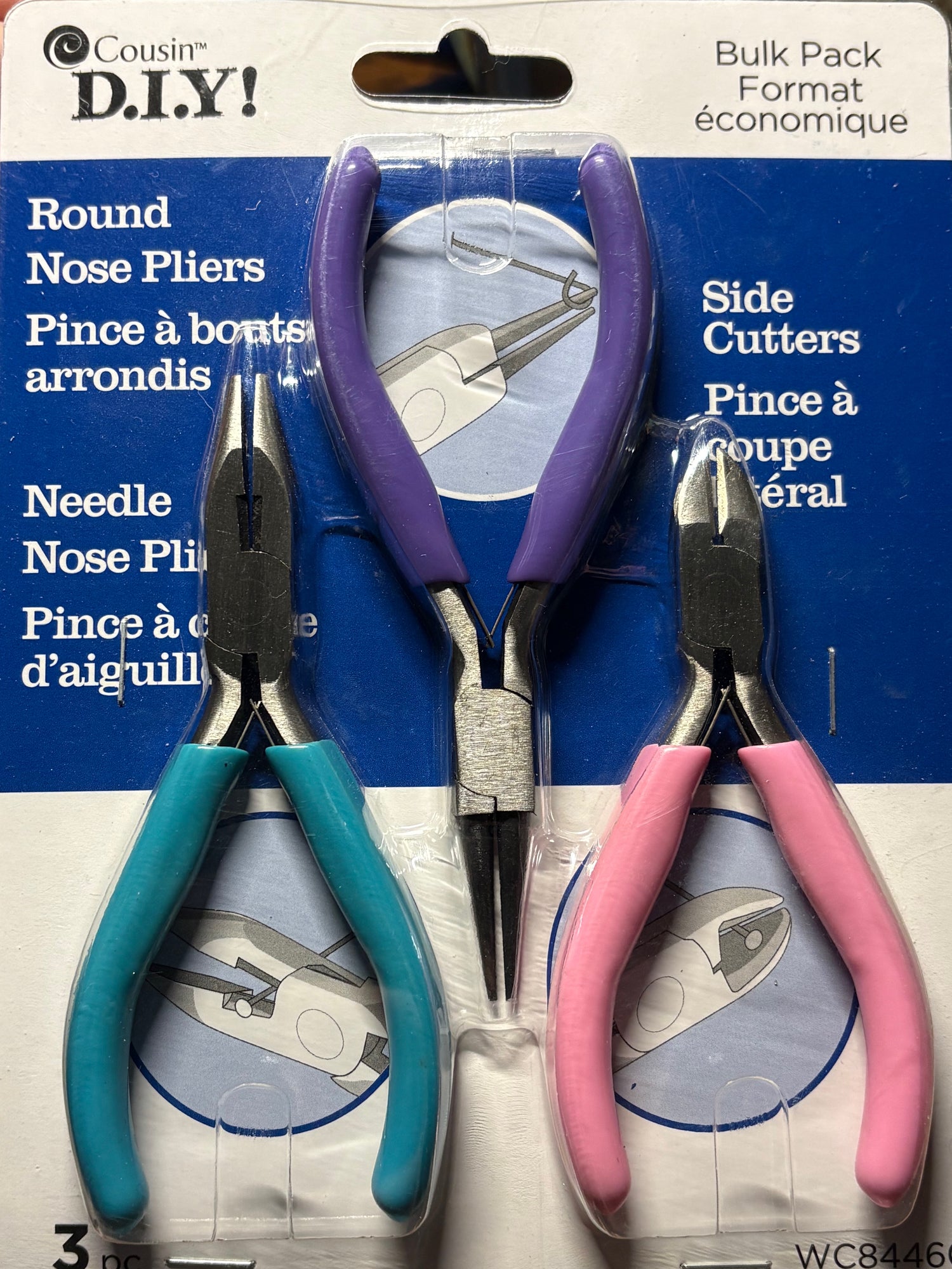 Set of pliers with colorful handles in packaging