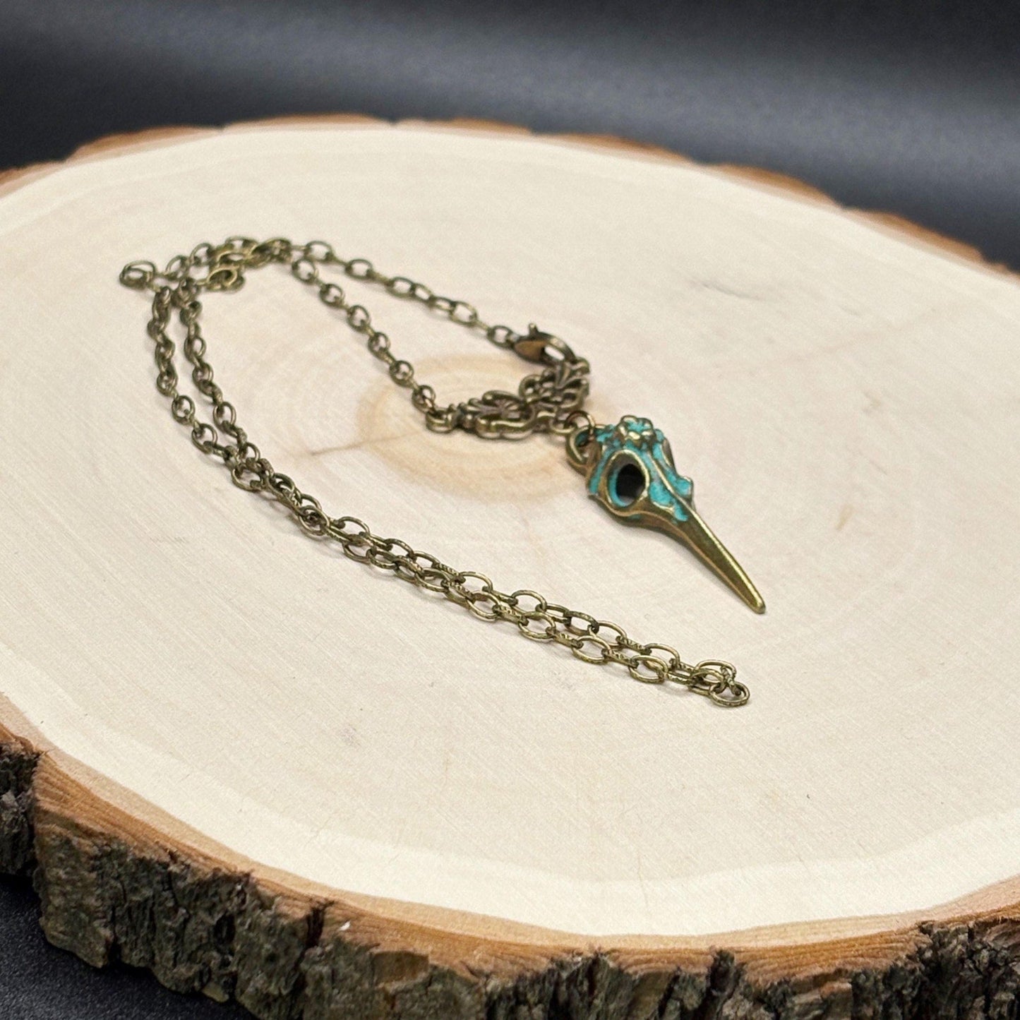 Necklace with a decorative pendant on a wooden surface