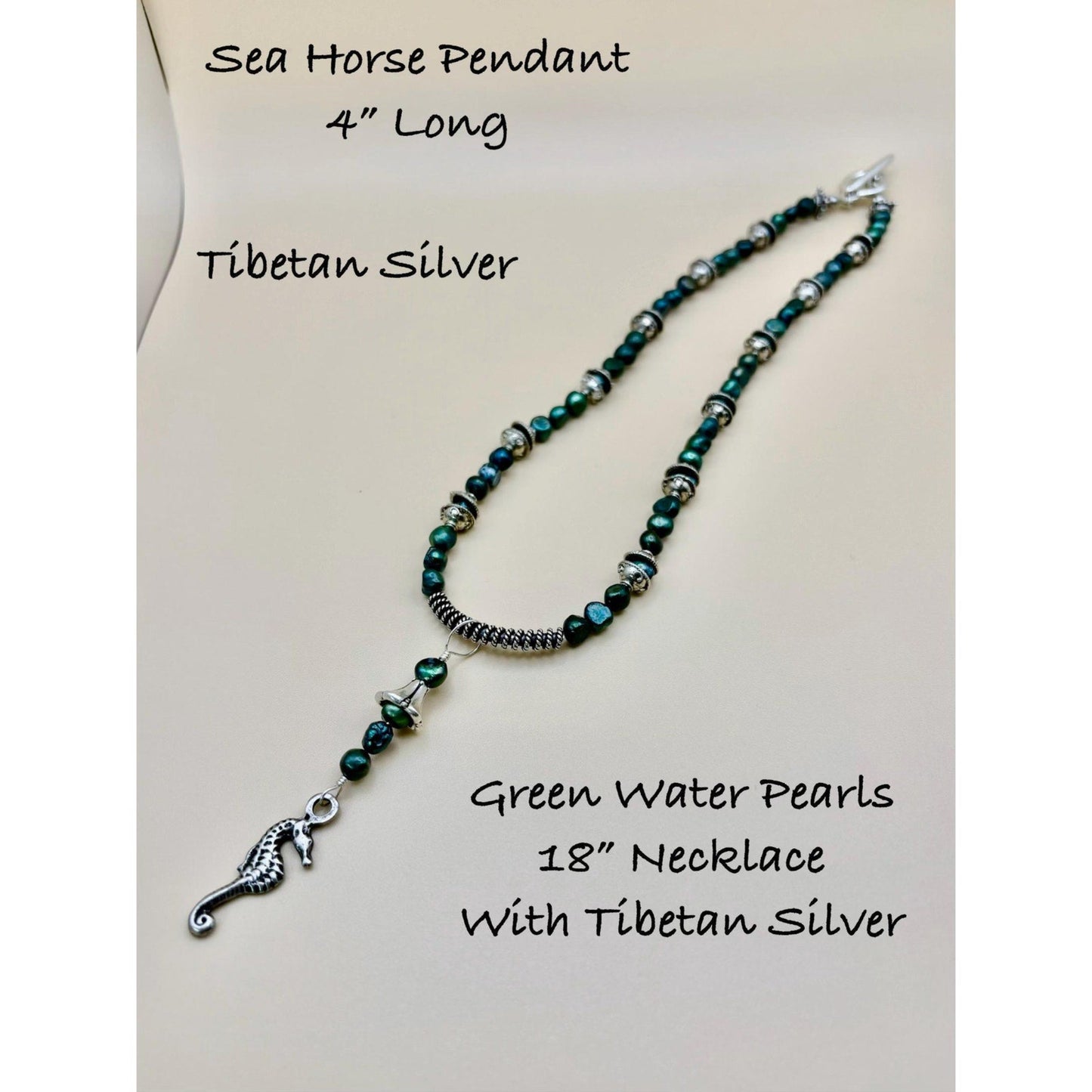 Necklace with green water pearls and Tibetan silver sea horse pendant on a white background