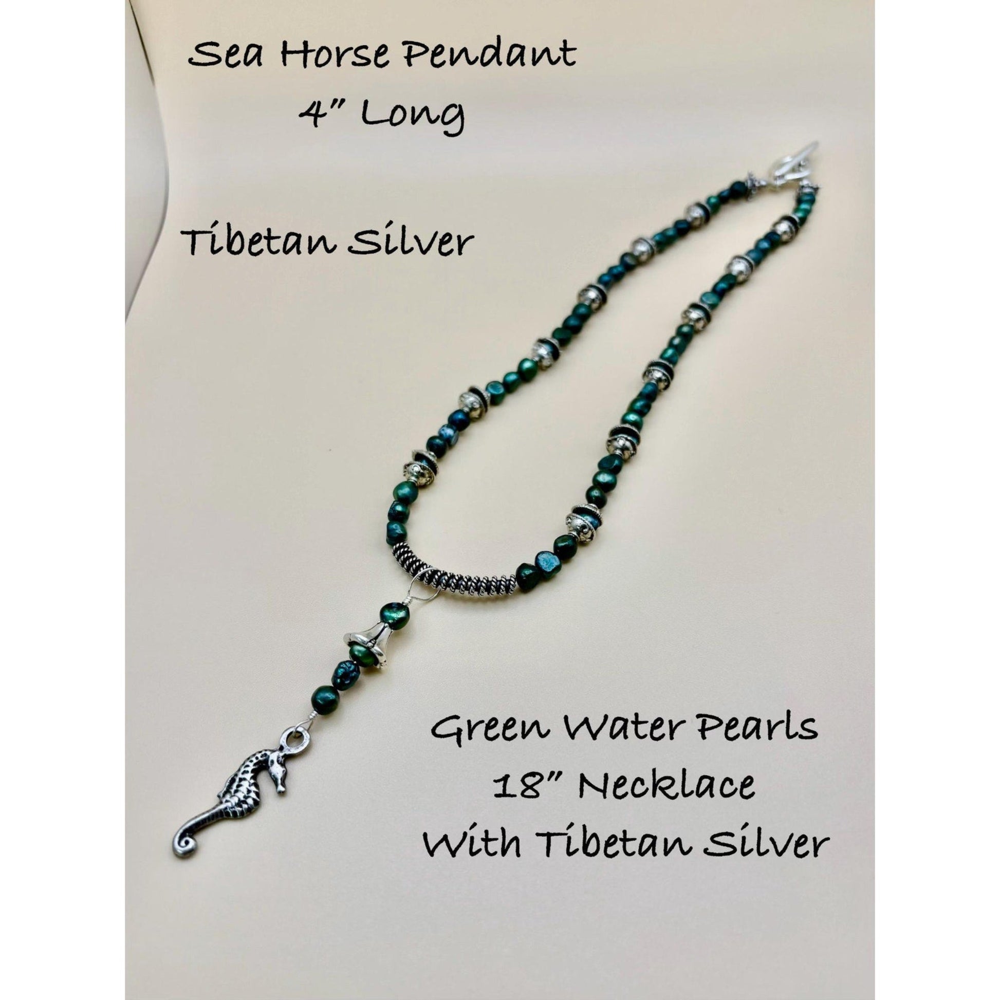 Necklace with green water pearls and Tibetan silver sea horse pendant on a white background