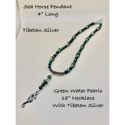 Necklace with green water pearls and Tibetan silver sea horse pendant on a white background