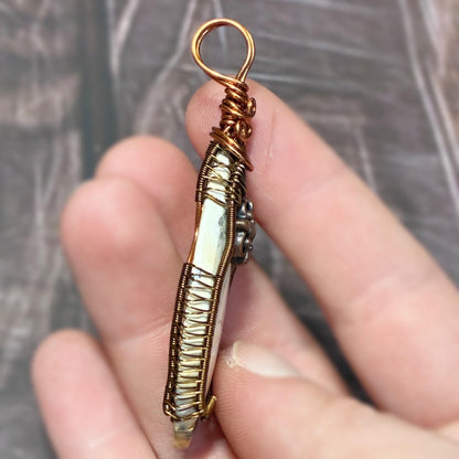 handmade pendant showing intricate wire woven design