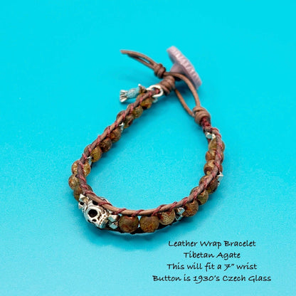 Leather wrap bracelet with agate stones and a button on a blue background