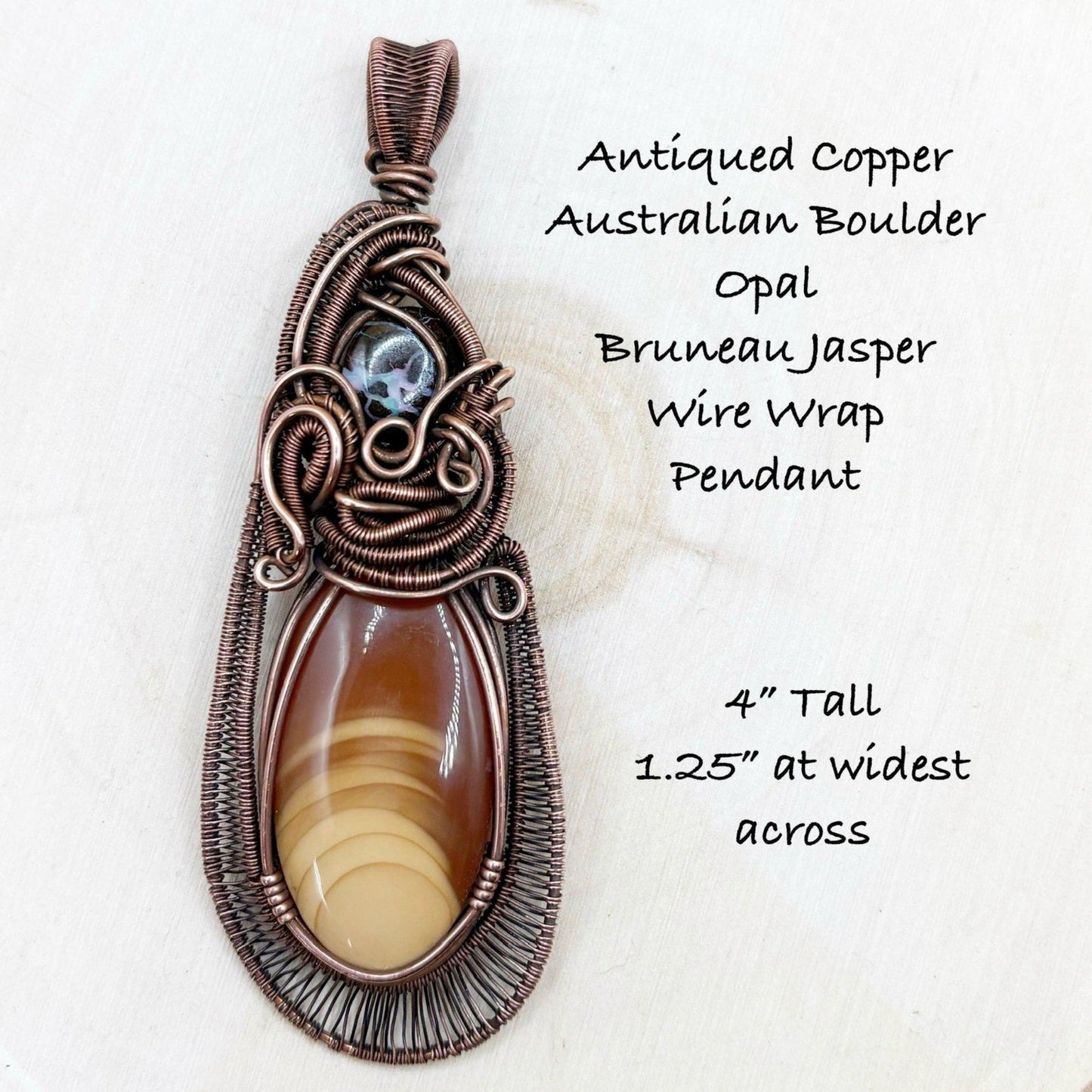 Antiqued copper wire wrap pendant with Australian Boulder Opal and Brunneau Jasper on a white background