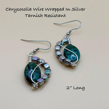 Chrysocolla wire-wrapped earrings on a beige background with text about material and length.