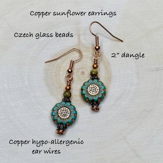 Copper sunflower earrings with Czech glass beads on a textured surface