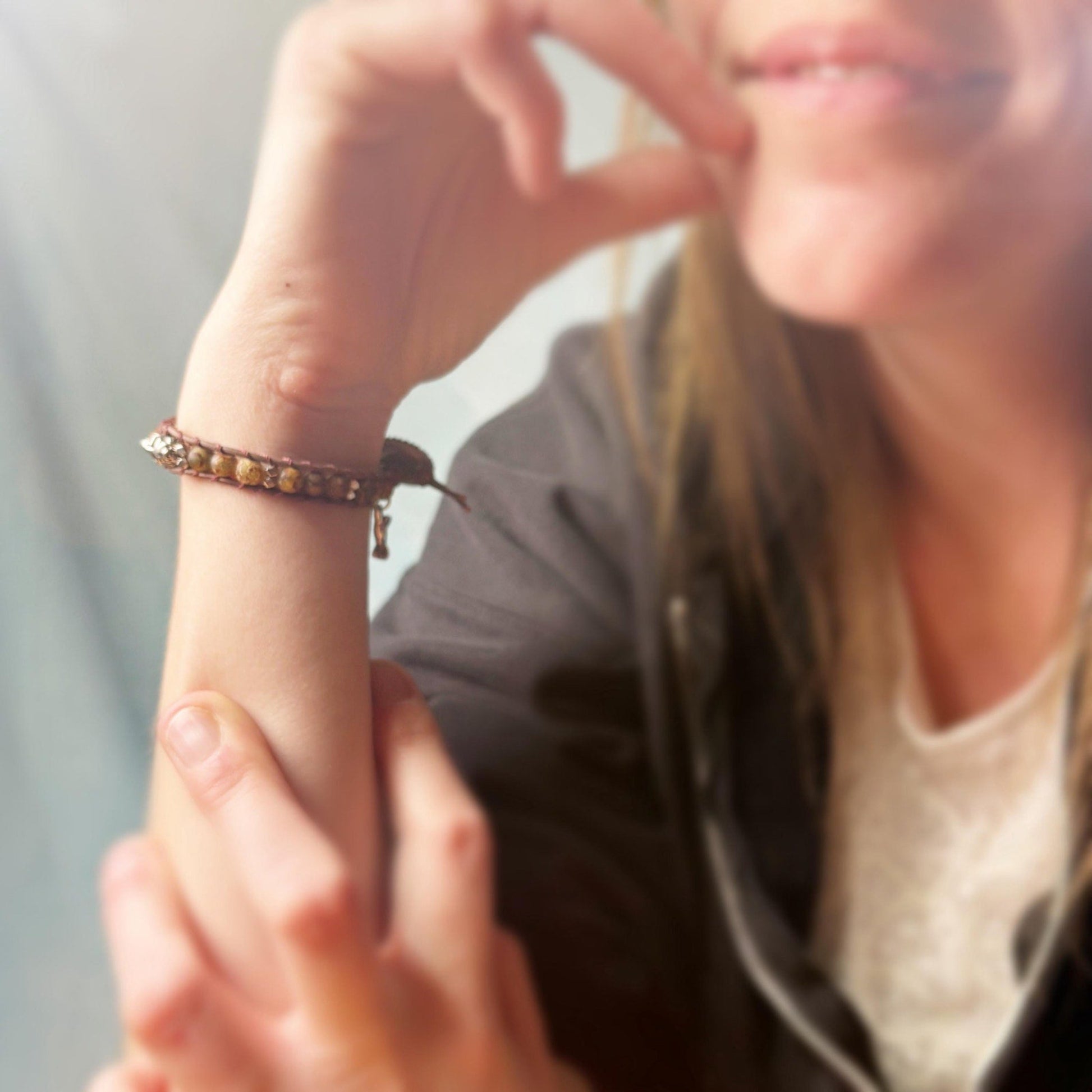 Close-up of a person wearing a bracelet on a blurred background