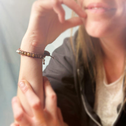 Close-up of a person wearing a bracelet on a blurred background