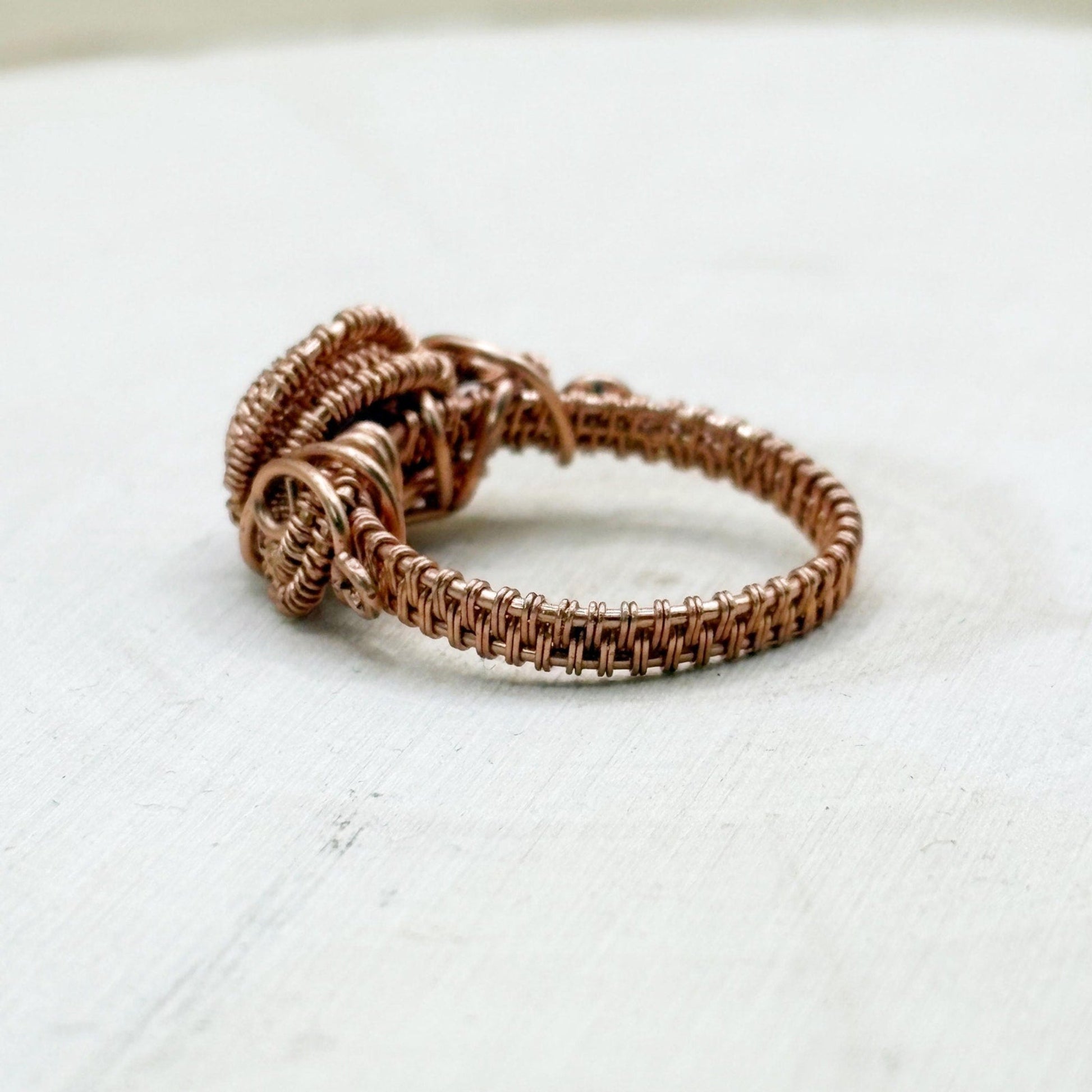 Copper wire ring on a light gray background