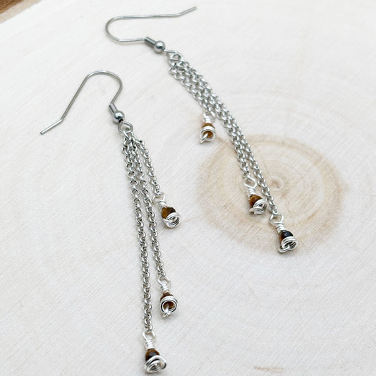 Silver tone earrings with chain dangle featuring brown tigers eye gemstones