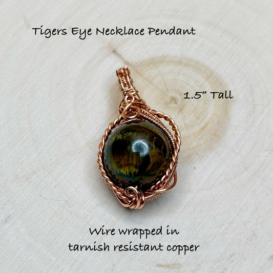 Tigers Eye Necklace Pendant with wire wrapping on a textured white background