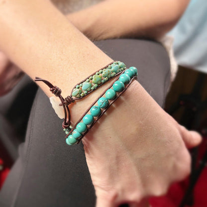 Turquoise beaded bracelets on a wrist with a blurred background