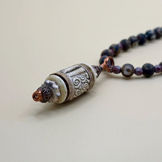 Necklace with a detailed pendant on a light background