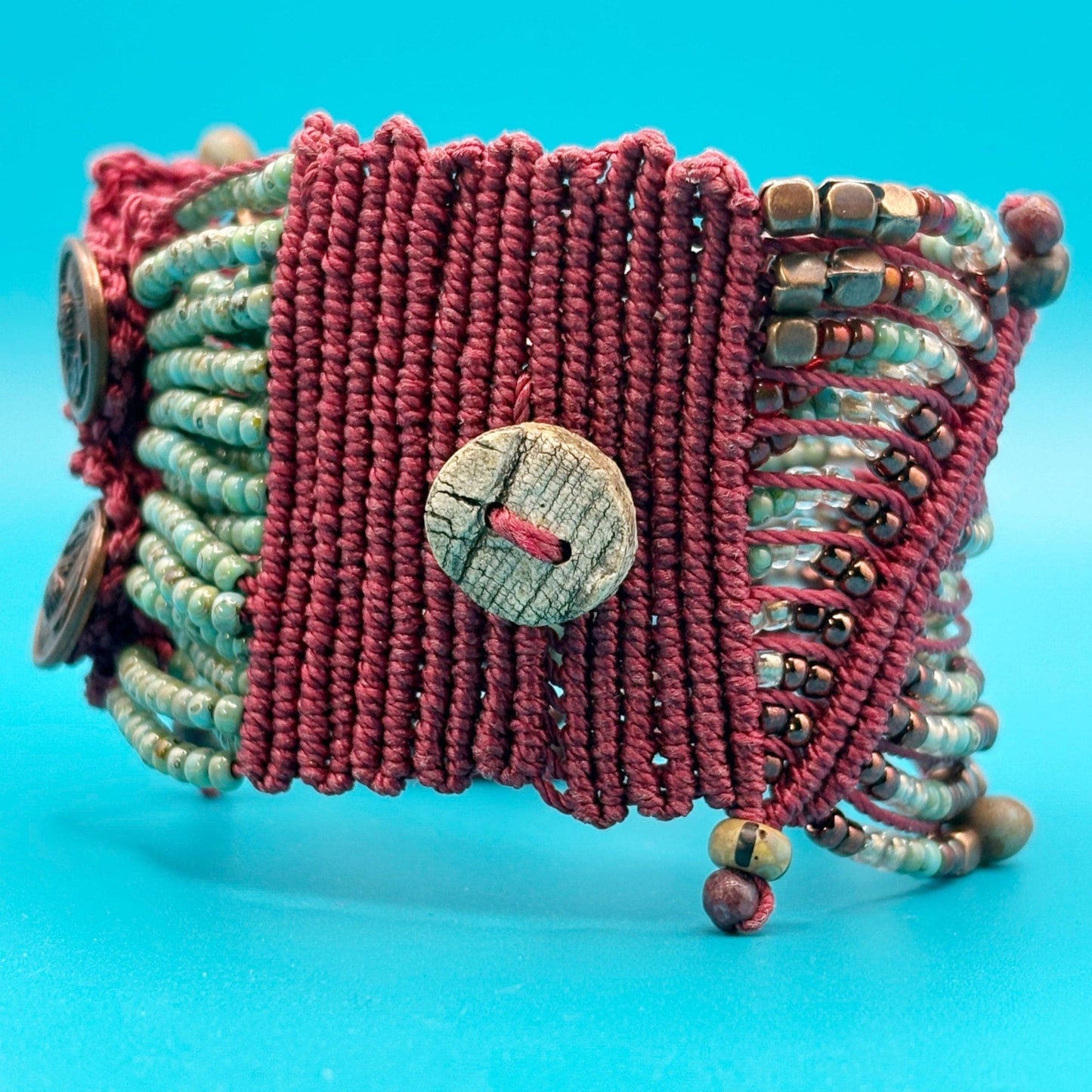 Textured bracelet with buttons and beads on a blue background