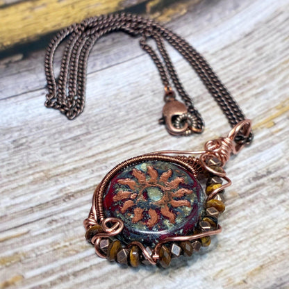 Wire wrap pendant in copper with a sunburst red glass coin with tigers eye beads on an 18 inch chain