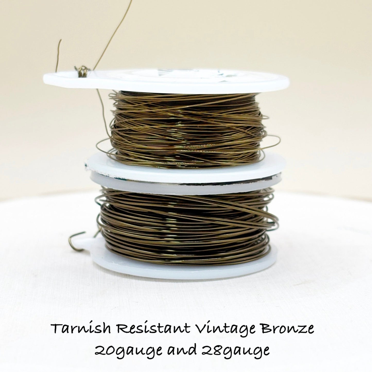 Spool of tarnish-resistant vintage bronze wire on a white background with text indicating gauge.