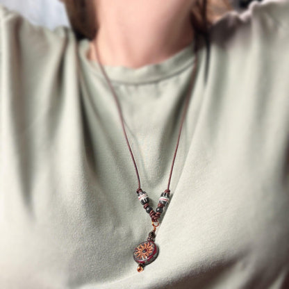 Necklace with a decorative pendant on a light green shirt