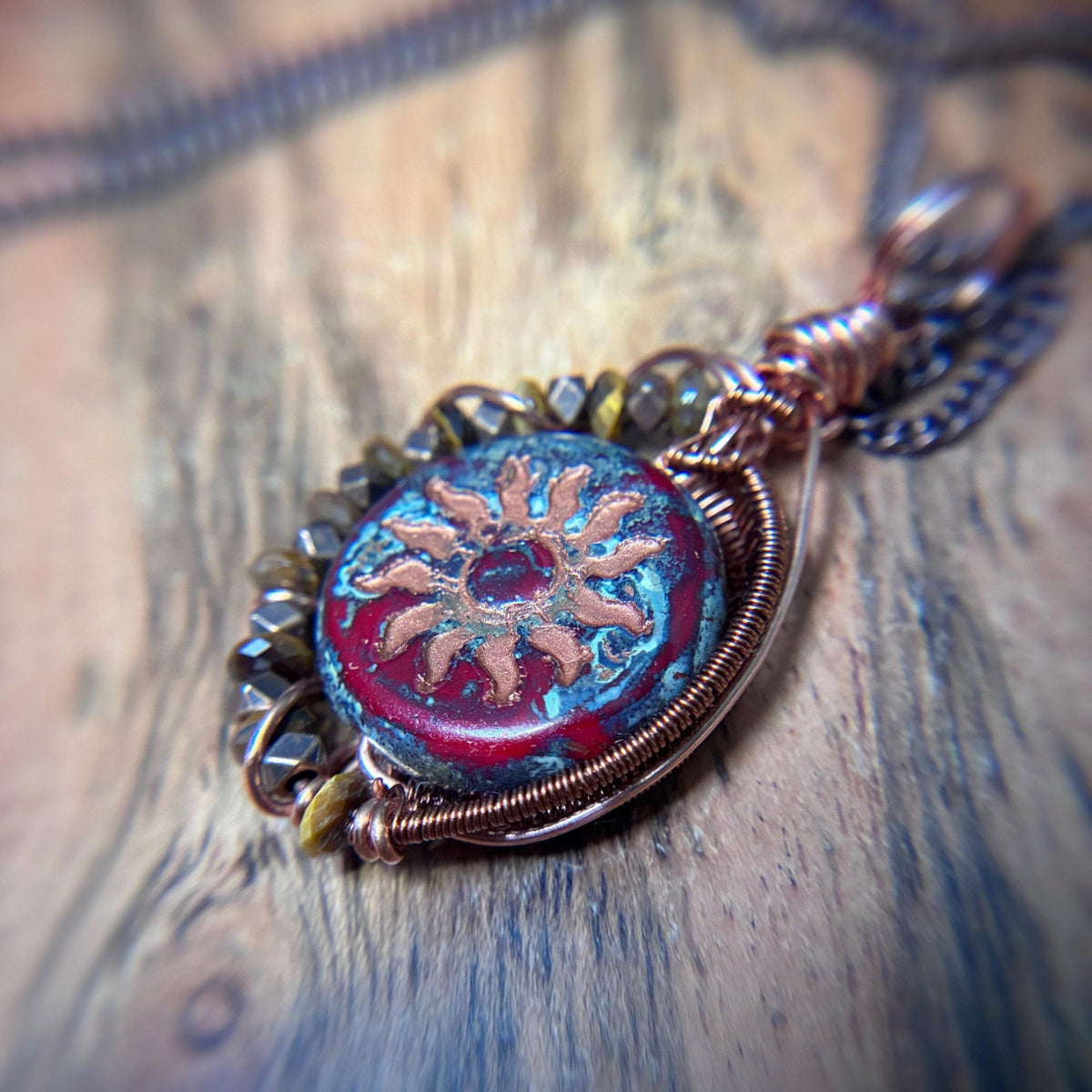 closeup photo showing the unique back side of red sunburst copper pendant