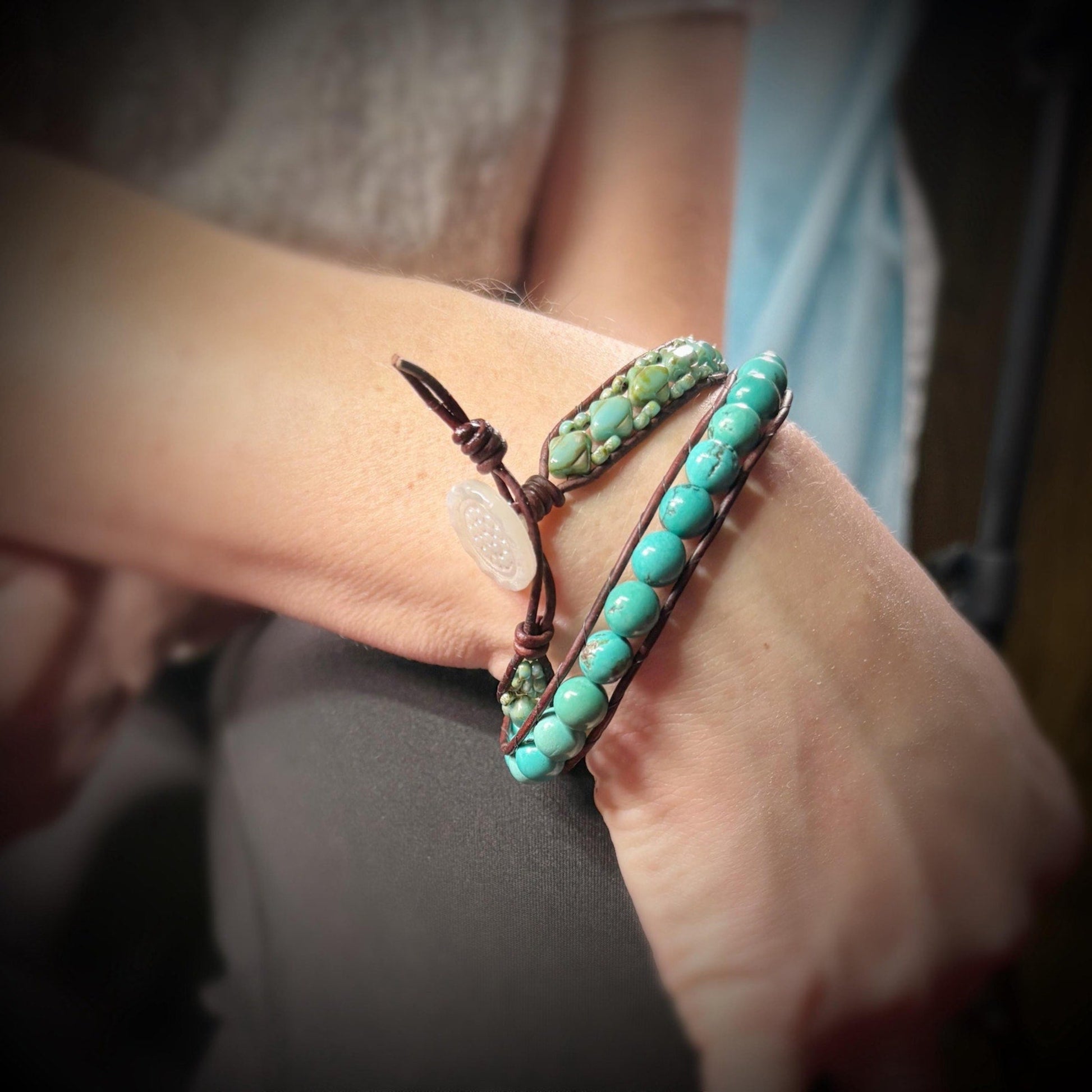 Turquoise beaded bracelet on a wrist with a blurred background