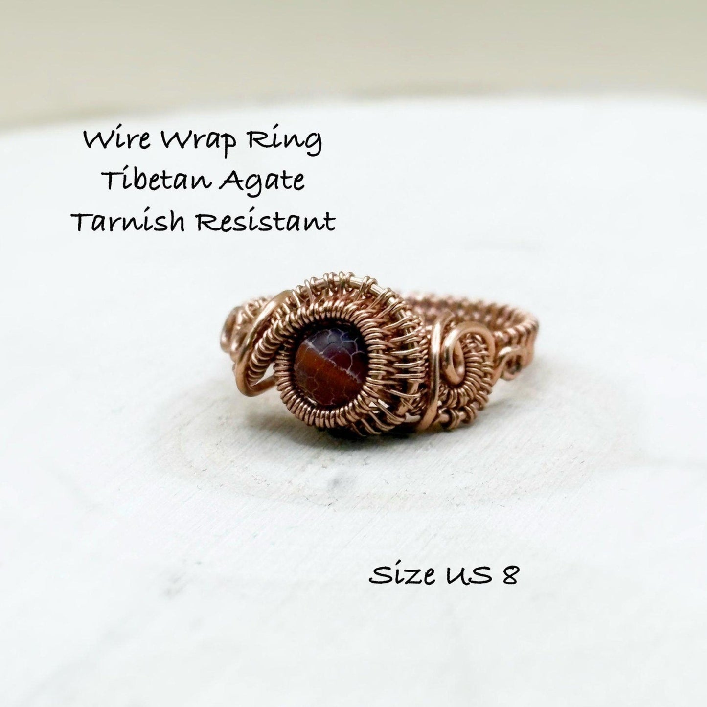 Wire wrap ring with Tibetan Agate on a white background