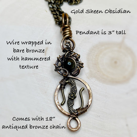 Gold Sheen Obsidian pendant with wire wrapping and hammered texture on a white background