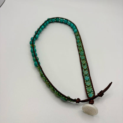 bracelet with turquoise and green beads on a white background