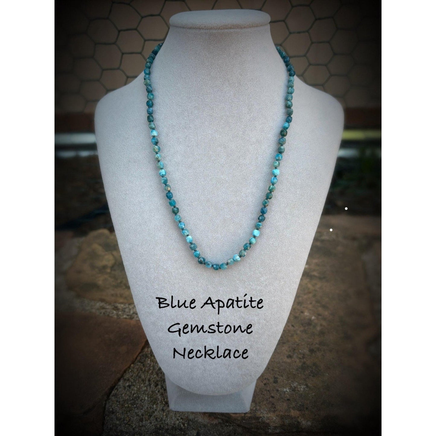 Blue Apatite Gemstone Necklace on a mannequin with a textured background