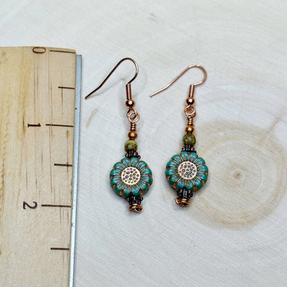 Ruler with earrings showing the 2 inch length of copper jewelry