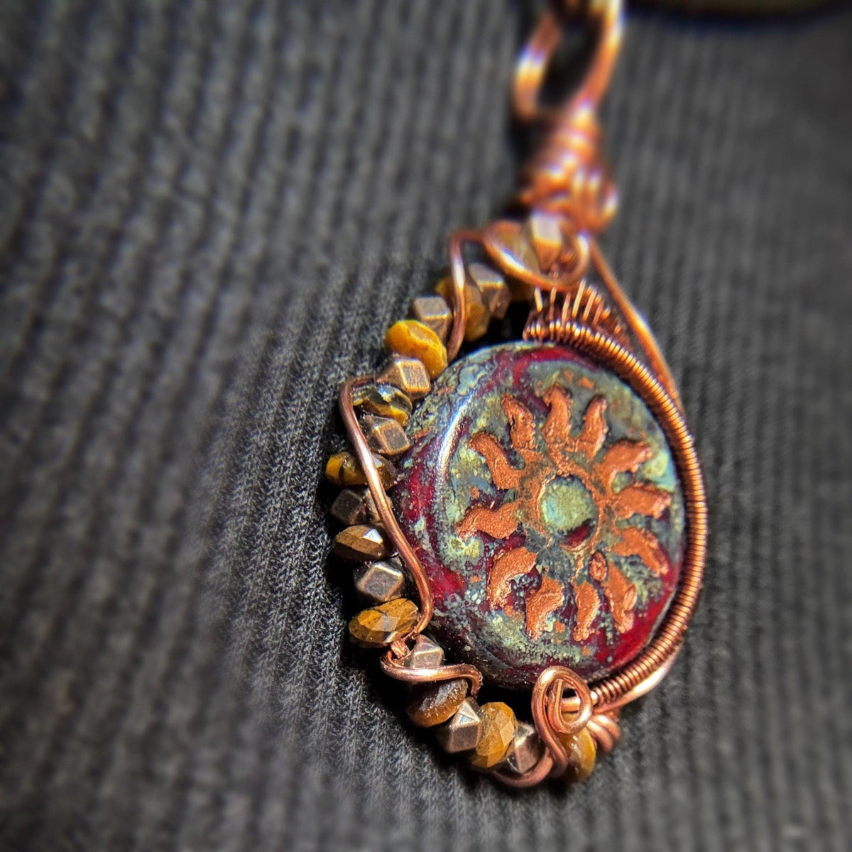 Handmade wire wrap copper pendant with brown crystals down the side