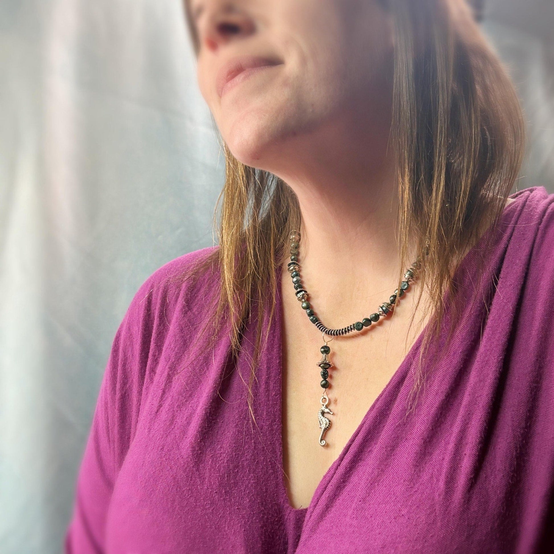 Woman wearing a necklace with a blurred background