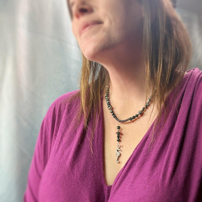 Woman wearing a necklace with a blurred background