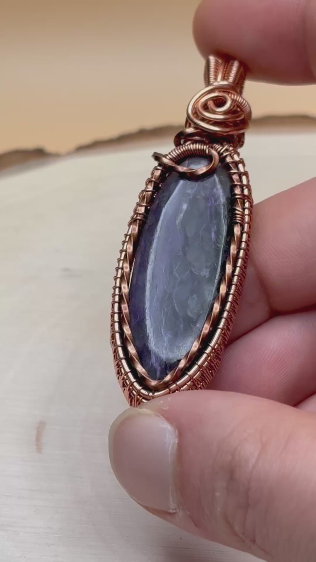 Video of pendant showcasing the stone and woven copper frame