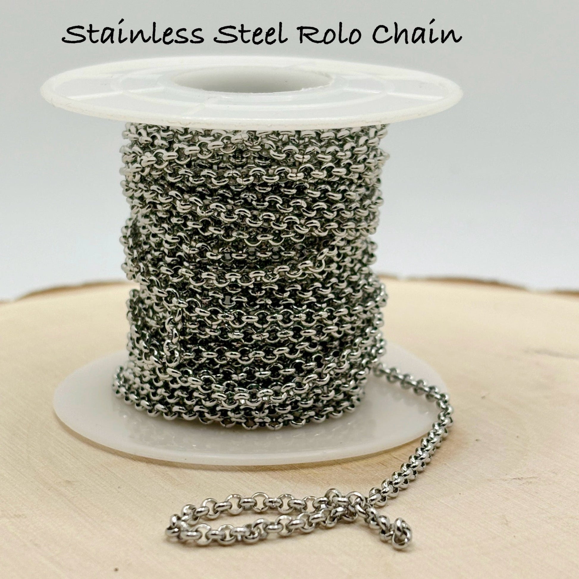 Spool of stainless steel Rolo chain on a white background