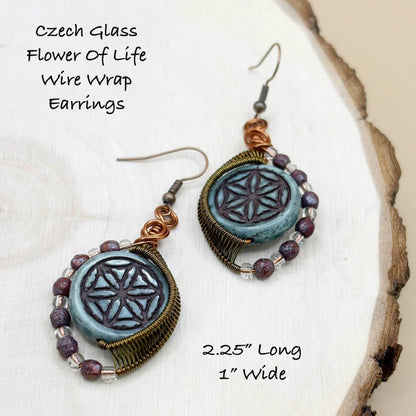 Czech Glass Flower Of Life Wire Wrap Earrings on a natural wood background